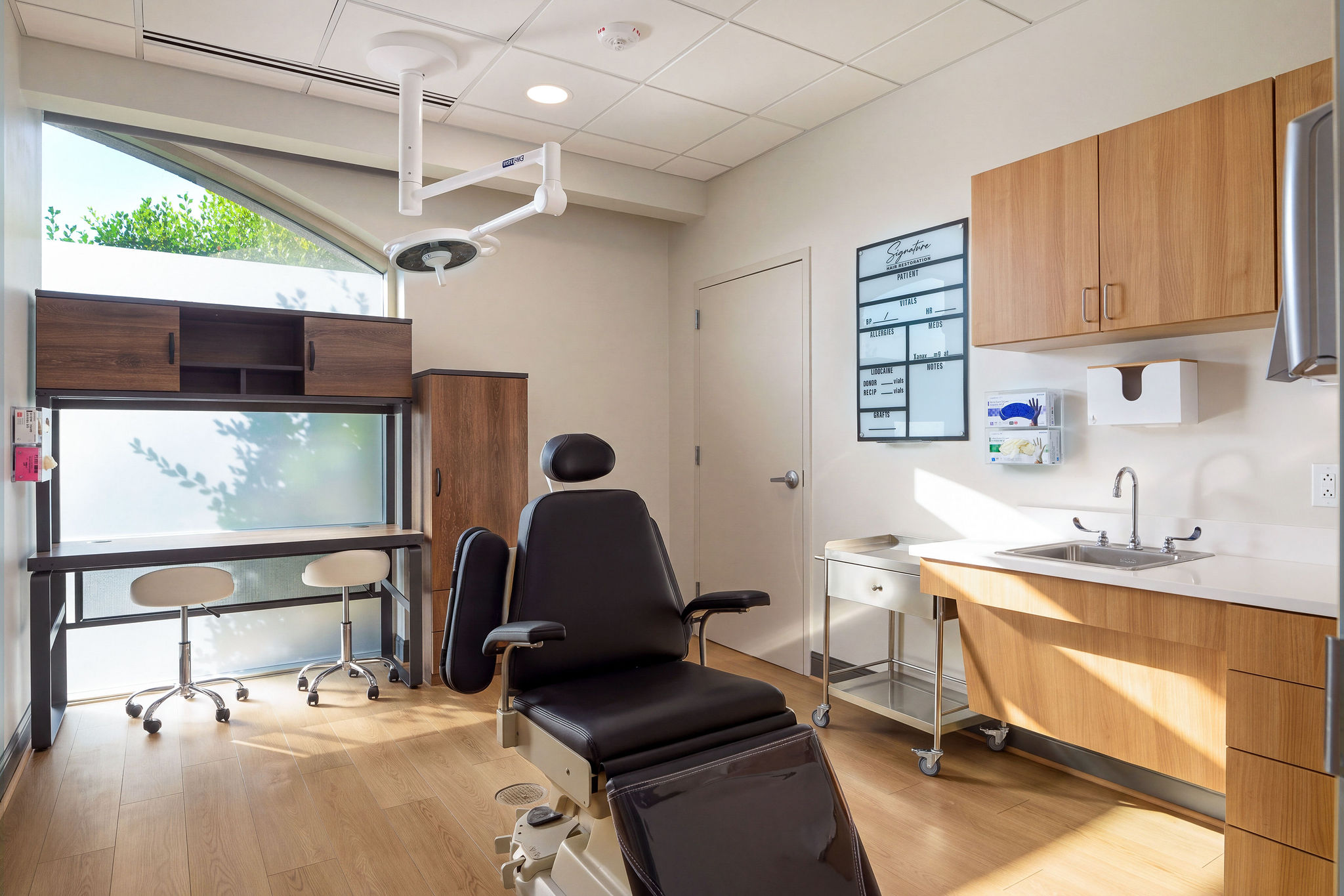 Treatment room with procedure chair and cabinetry
