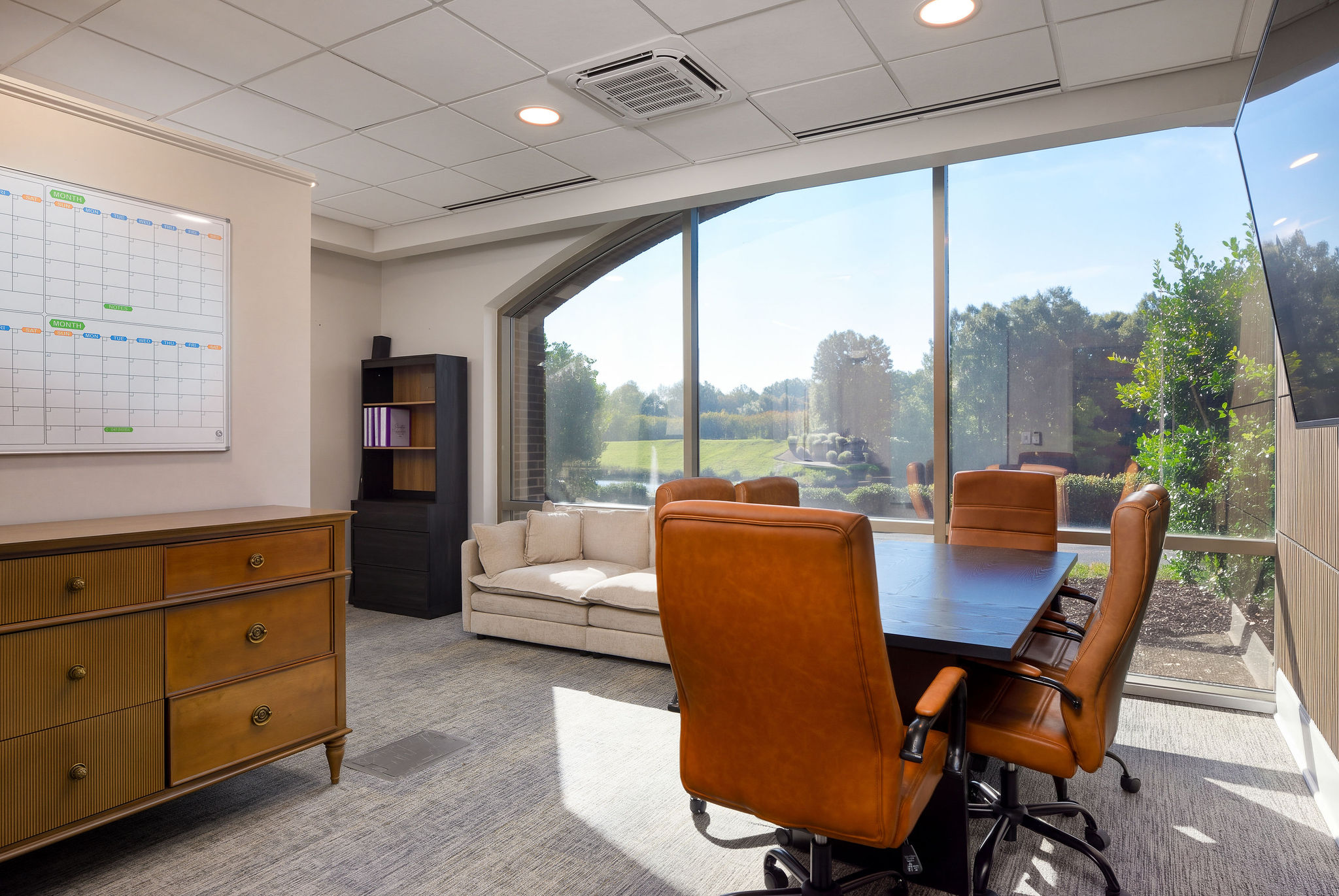 Consultation and meeting room with table, chairs, and lake-facing windows