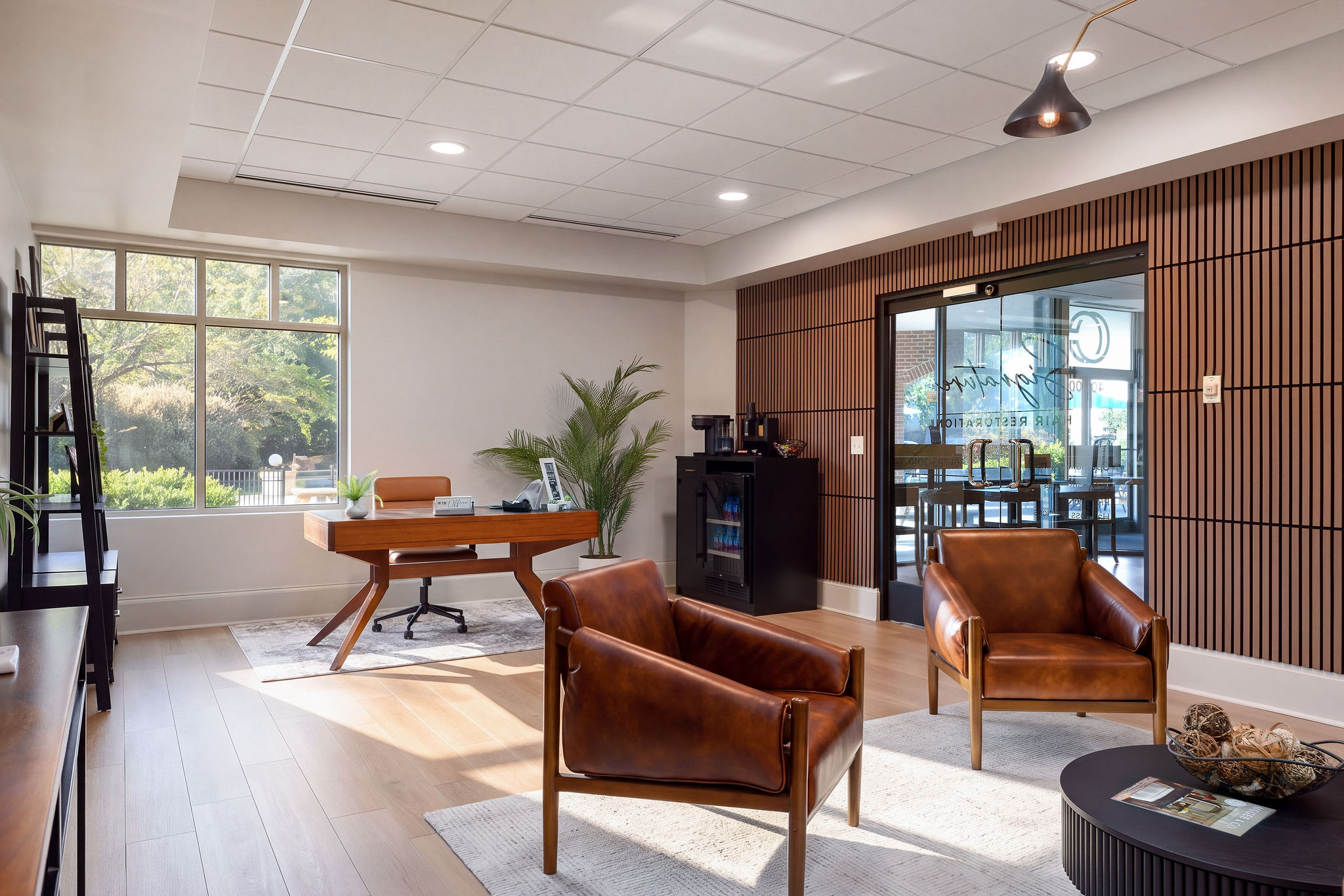 High Point reception lounge with leather chairs, a table, and large windows