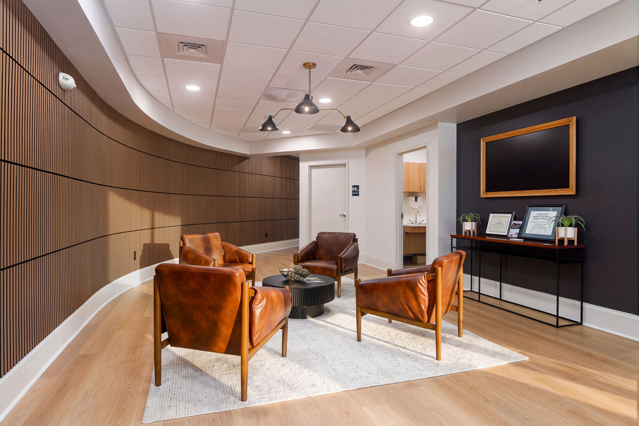 Reception lounge with leather chairs and wood-paneled walls