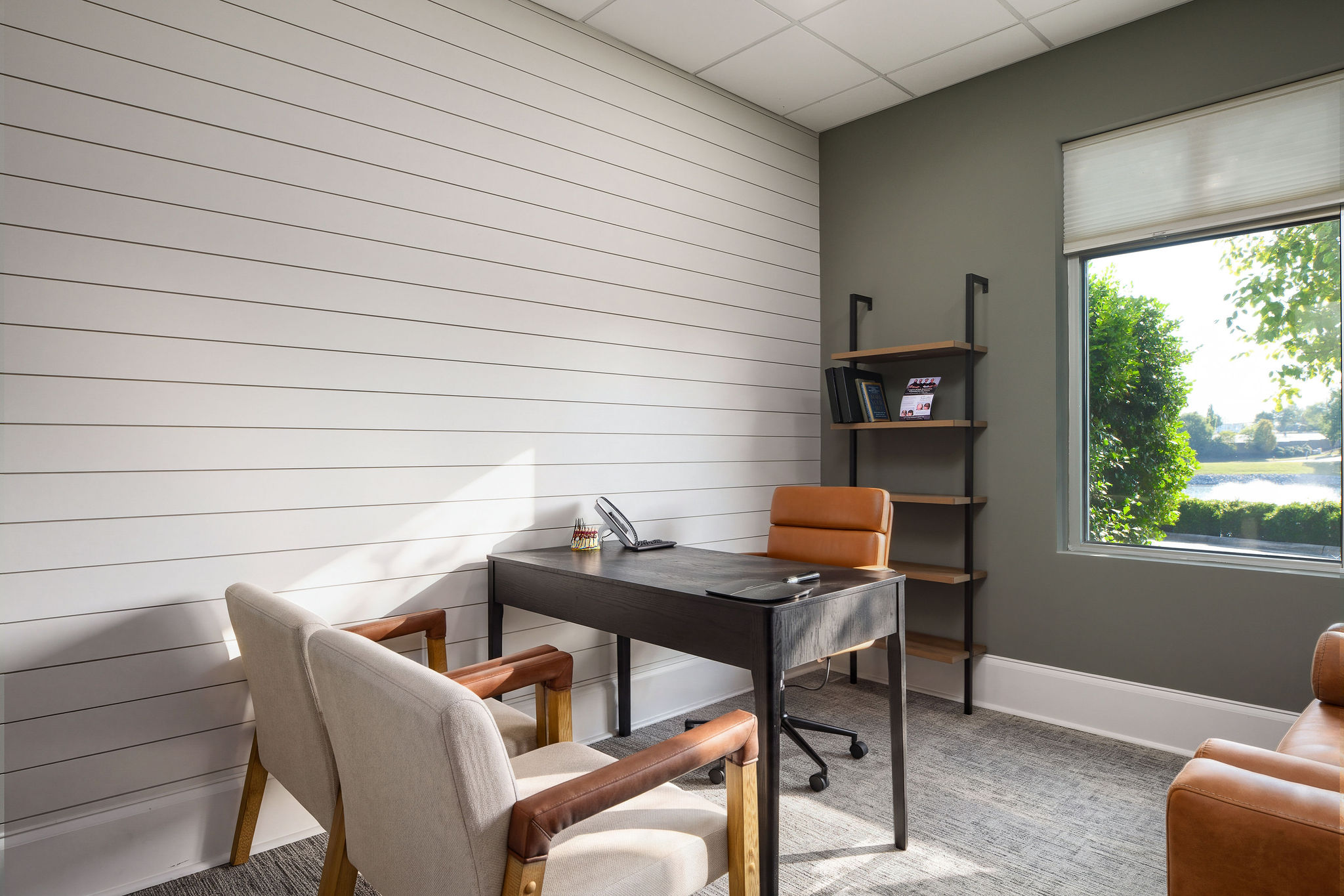 Private consultation room with desk and seating