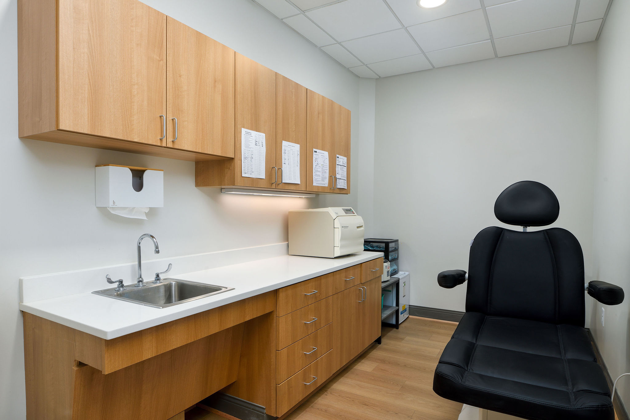 Examination room with reclining chair and sink